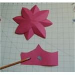 put a dab on paint on a scrap of paper and use the end of a pencil eraser to put dots in the center of the flower
