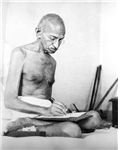 Ghandi Writing Reflectively (Public Domain)