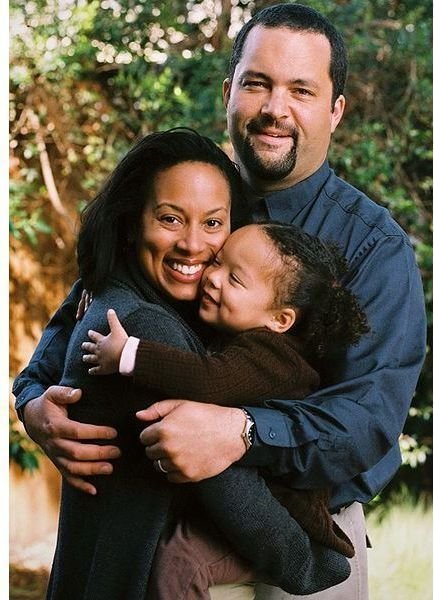 Parents holding their toddler.