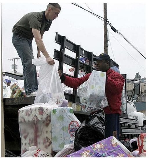 Supply Department unload packages donated to the Christmas Angels gift drive