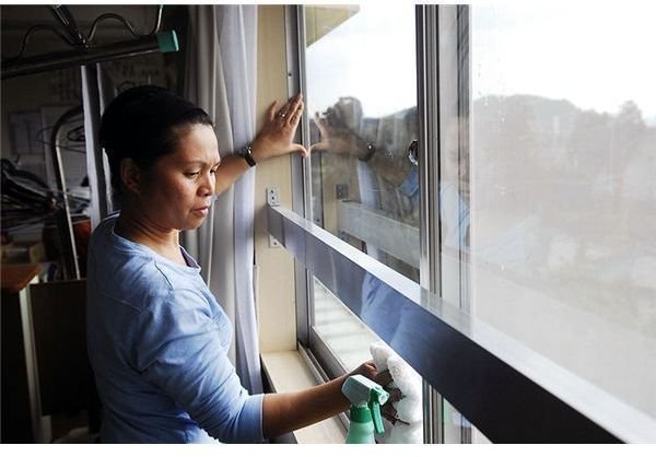 800px-US Navy 090301-N-9610C-048 Lt. Lelanie Aratea, from San Diego, cleans windows in the common room of the Kibono Ie nursing home in Saikai-cho town during a community service project