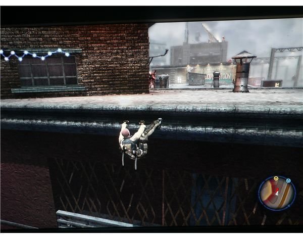 Cole McGrath hanging from one of the rooftops, with some enemies nearby.