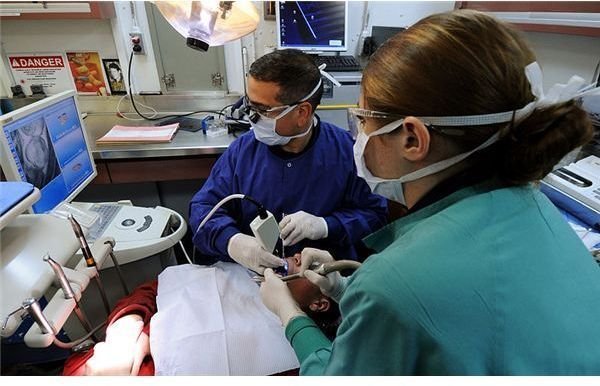 800px-US Navy 100925-N-5685W-028 Cmdr. Jorge Graziani, left, the ship&rsquo;s dental officer, and Hospital Corpsman 3rd Class Megan Castle, a dental hygienist