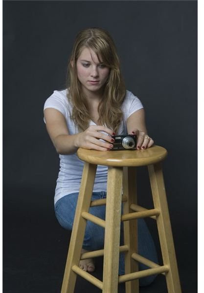 Porsche braces her camera on a stool.