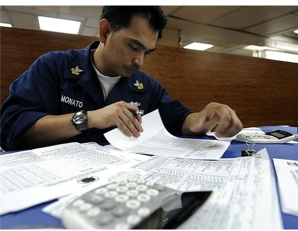 795px-US Navy 091028-N-7280V-170 Culinary Specialist 1st Class Neil Monato verifies figures on a food preparation worksheet while underway aboard the amphibious command ship USS Blue Ridge (LCC 19)