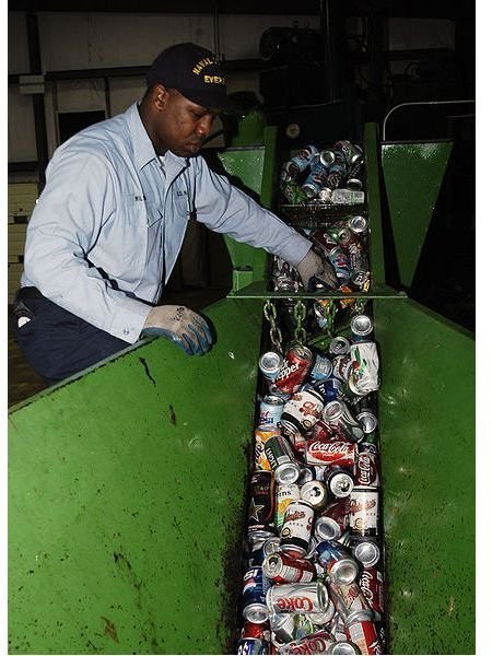 428px-US Navy 050531-N-9293K-003 Fireman Brian Wilson of Charleston, S.C., separates bottles from aluminum cans at the Navy Recycling Center on board Naval Station Everett, Wash