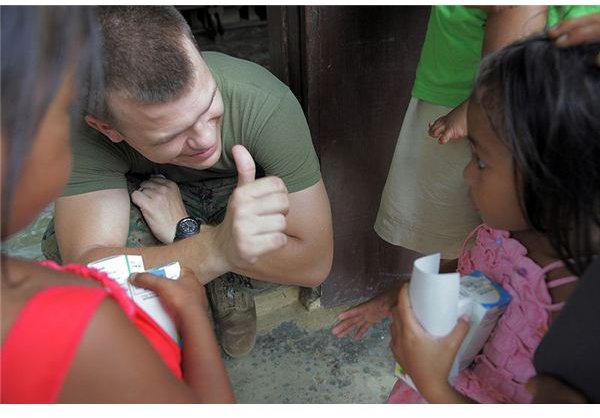 r Juchniewicz, gives a thumbs up while handing out medication during a medical civic action project supporting Balikatan 2009 at Nakar Elementary School