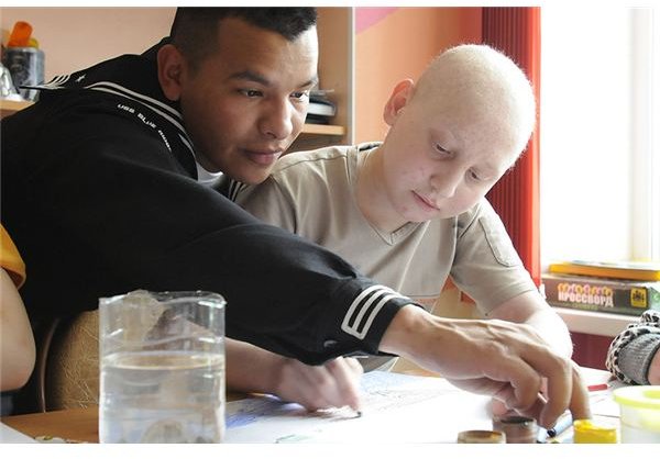 800px-US Navy 100507-N-9094S-375 Logistics Specialist Seaman Sergio Torres draws pictures with a child at the Vladivostok children&rsquo;s cancer ward