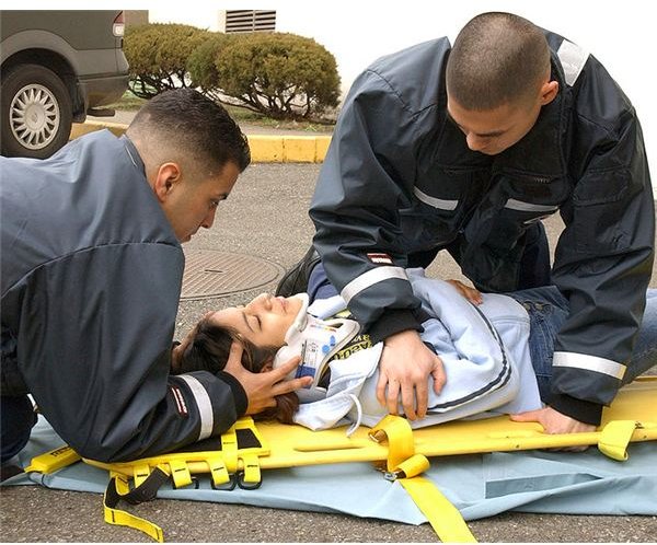 Hospital Corpsman Fernando Prieto and Hospital Corpsman Raulito Galgana demonstrate life saving techniques in the parking lot outside the Emergency Room of U.S. Naval Hospital Yokosuka, Japan