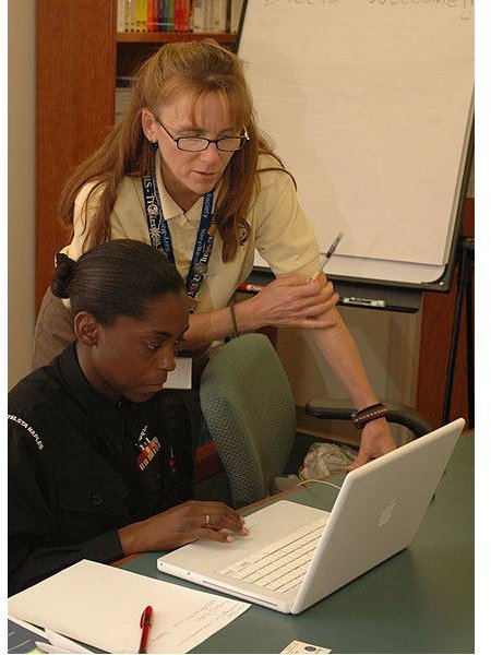 428px-US Navy 091104-N-7434C-080 Kirsten Trussler, a relief services assistant for the Navy and Marine Corp Relief Society, shows information Systems Technician Kimberly Parker how to use budgeting software