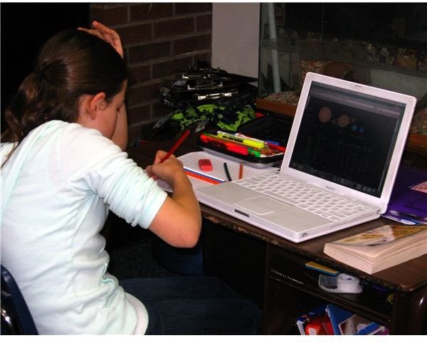 Student combining efforts on paper and computer to enhance learning.