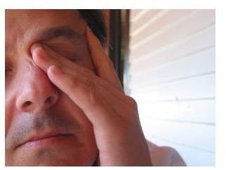 Man Rubbing Eyes