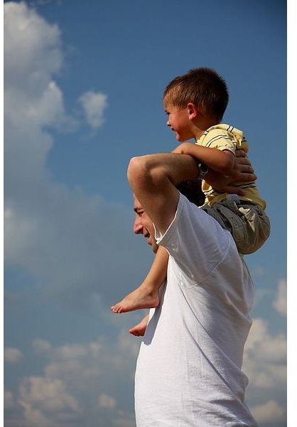 Son on father&rsquo;s shoulders.