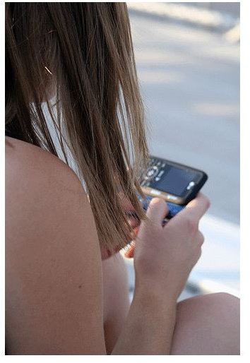 A teenager text IMing via phone.