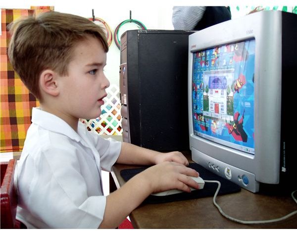 Child playing educational game on computer.