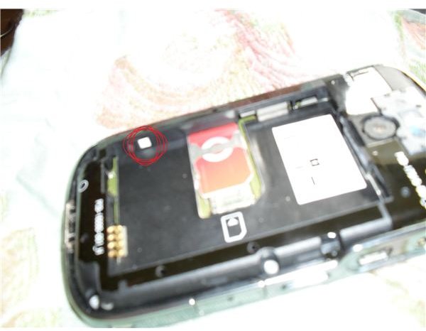 The water indicator on this BlackBerry bold is located left of the Sim, under the battery