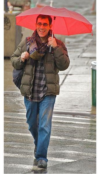 Happy man in a rainy day - You&rsquo;d smile, too, if you just got a job after being unemployed for the last six months!