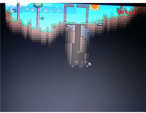 Digging below the surface in Terraria to find ore that&rsquo;ll help craft some equipment when starting out.