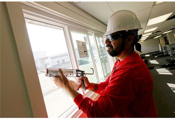 800px-US Navy 100809-N-8863V-043 A construction worker installs new energy-efficient windows in Bldg. 519 at Naval Surface Warfare Center