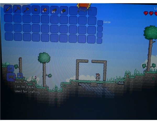 A look at the crafting menu in Terraria, where you can build a work bench.