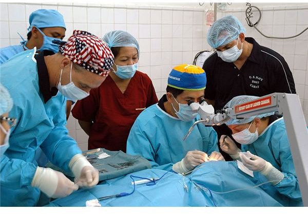 U. S. Navy Cmdr. David Lu performs delicate cataract surgery on a patient while members of the Philippine Navy medical team, along with U.S. Navy nurses and hospital corpsman assist and observe